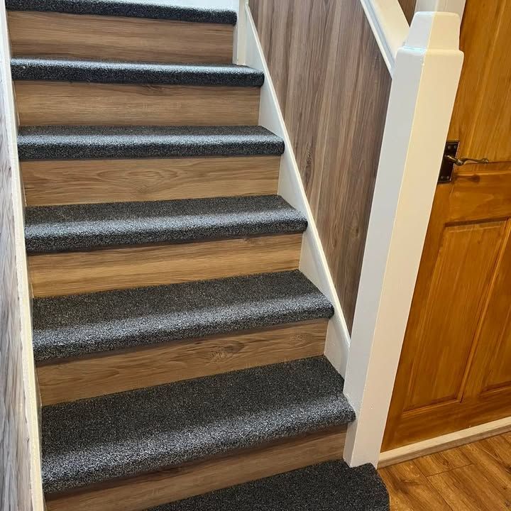 Charcoal carpet treads with wood-effect vinyl risers on a staircase