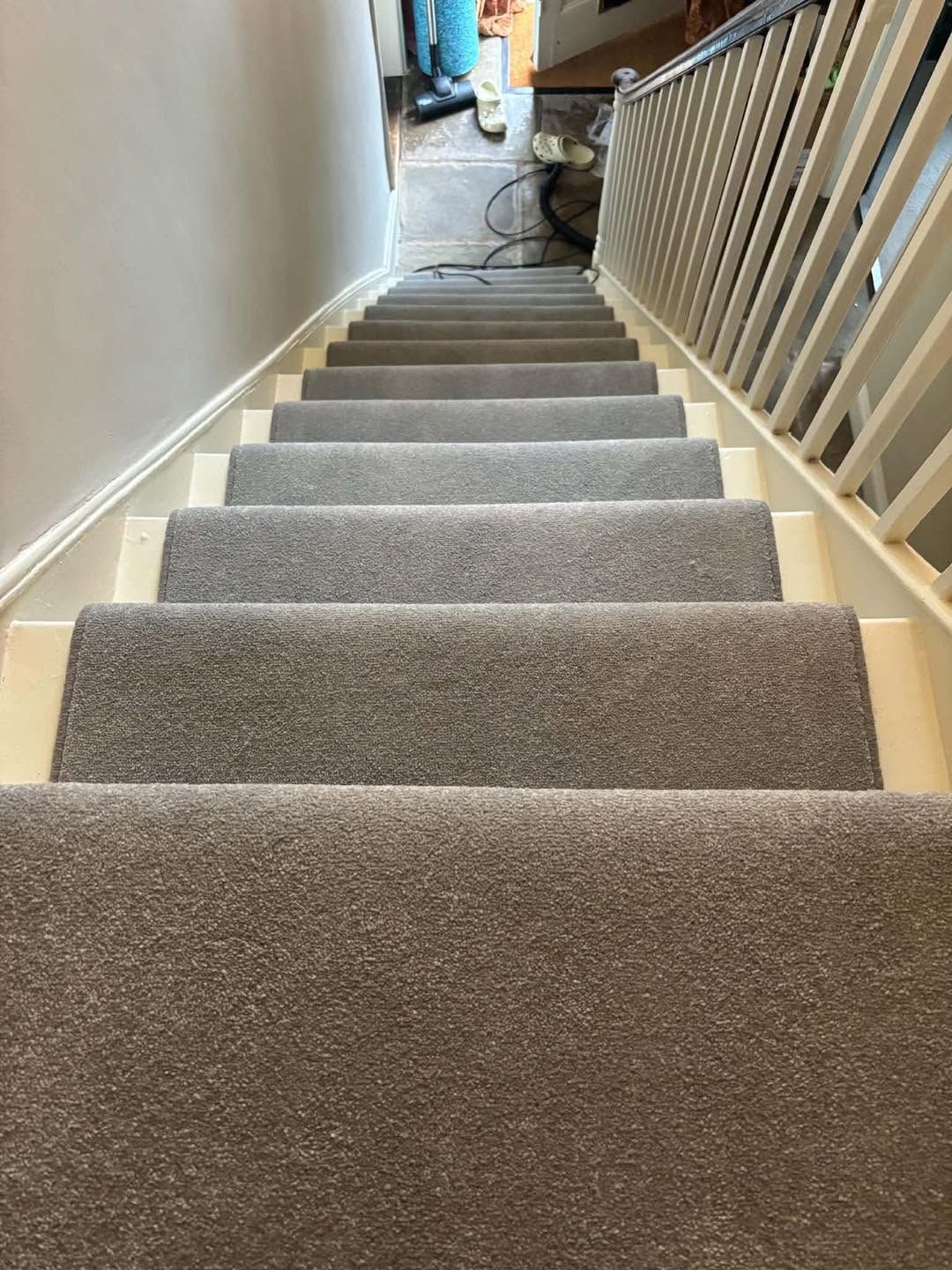 Grey stair carpet with white spindles