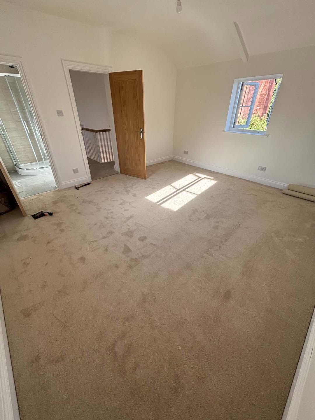 Beige carpet fitted in a bright room