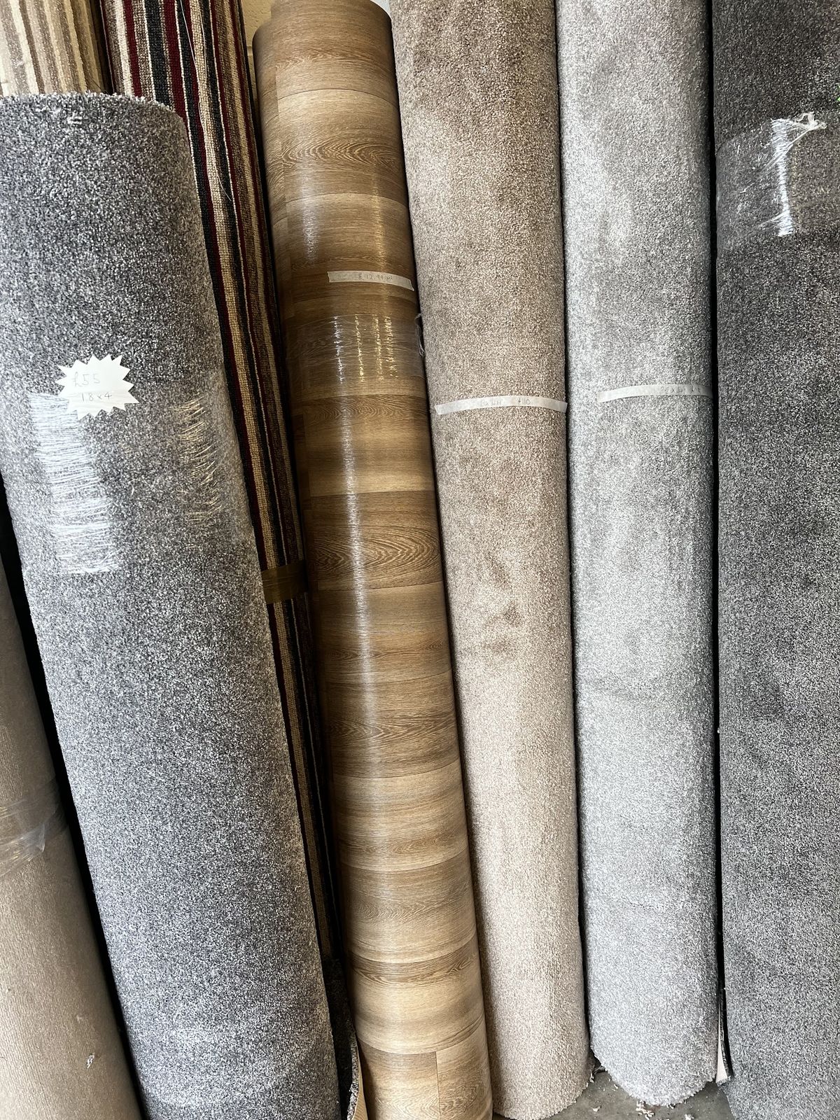 Close-up of carpet and wood-effect vinyl rolls