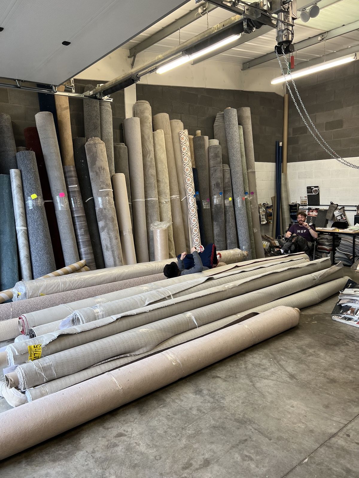 Carpet rolls laid out across the warehouse floor